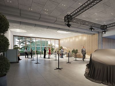 Spacious exhibition hall with high ceiling, lighting fixtures, attendees at tables, and large windows letting in natural light.
