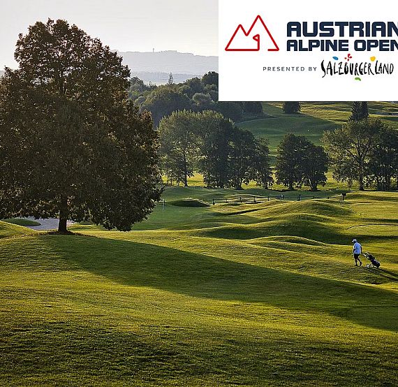 A golfer walks on a lush green golf course with hilly terrain and a large tree, promoting the Austrian Alpine Open 2025.