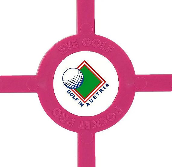 A pink golf alignment tool with a circular logo in the center featuring a golf ball and "GOLF IN AUSTRIA" text, designed to assist in practicing accuracy.