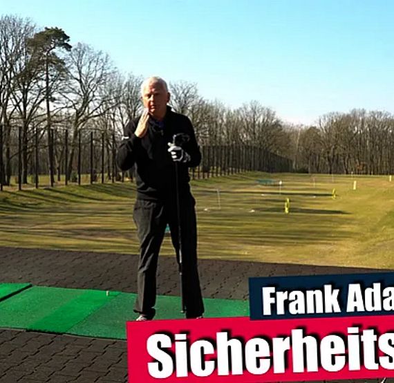 A golf instructor stands on a driving range, surrounded by trees, demonstrating techniques. The scene is set in an outdoor, lush environment.