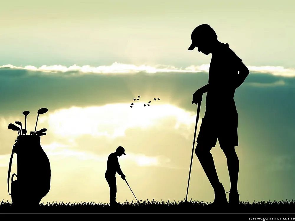 Silhouettes of two golfers at sunset; one stands, the other swings. Golf bag and flying birds add to peaceful, scenic atmosphere.