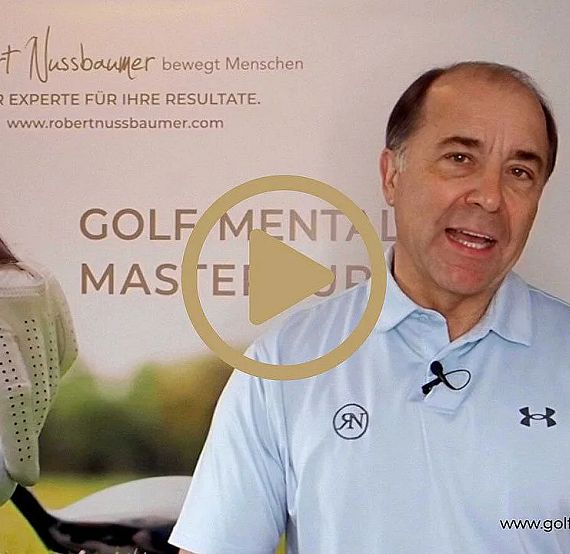 A man in a light blue shirt talks about golf mental mastery in front of a promotional banner.