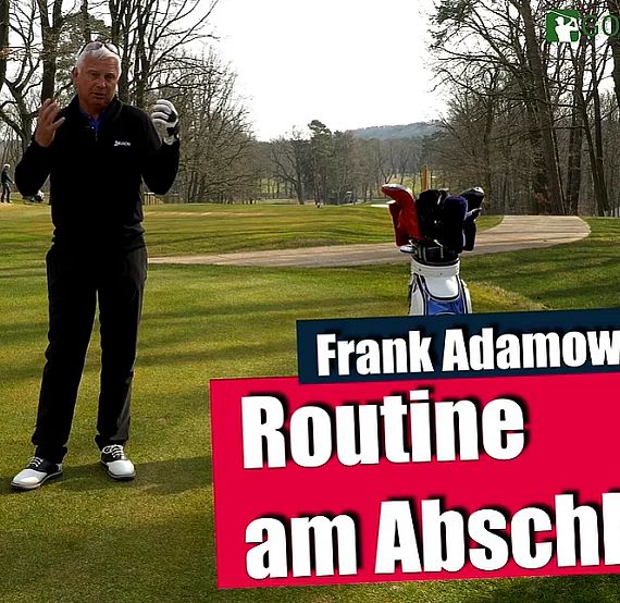 A man stands on a golf course near his clubs, explaining pre-shot routine techniques. Trees line the background, and the grass is green and well-maintained.