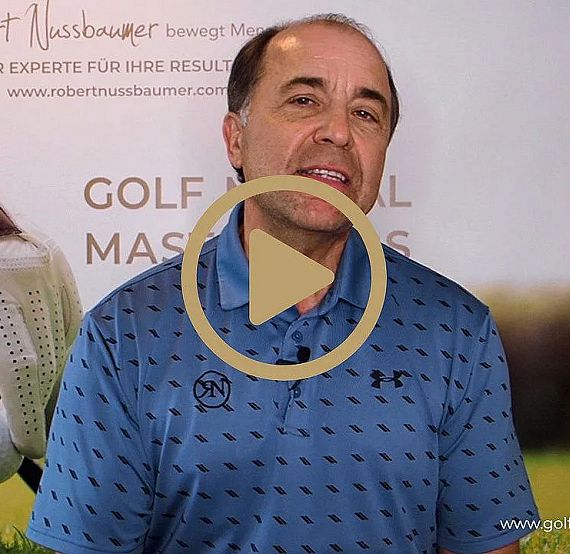 A man in a blue polo stands before a golf lesson banner, suggesting expertise and promotion of golf training and skill improvement.