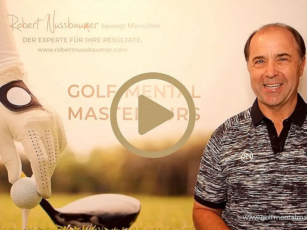 A man in a golf shirt smiles beside a sign about mental mastery in golf, showcasing a gloved hand placing a golf ball on a tee.