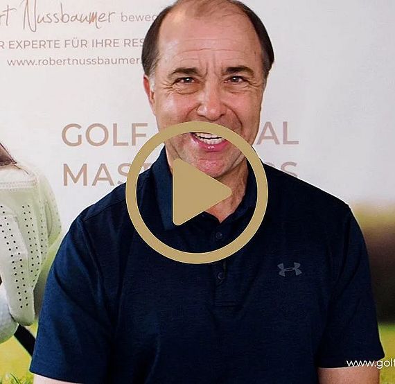 Man smiling in front of a golf promotional background featuring a gloved hand and golf ball. Play button overlay suggests video content.