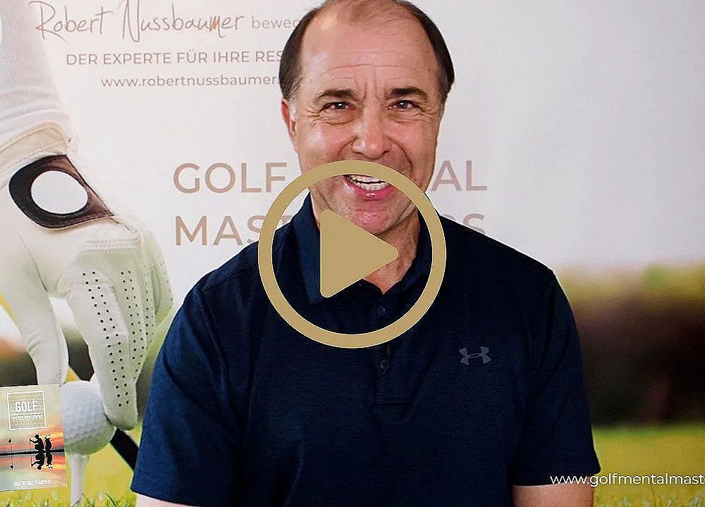 Man smiling in front of a golf promotional background featuring a gloved hand and golf ball. Play button overlay suggests video content.