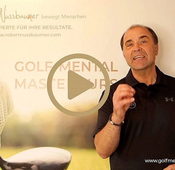 A man in black shirt speaks enthusiastically in front of a banner about golf mental mastery.