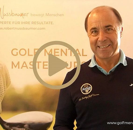 A smiling man in a black sweater stands in front of a golf-themed banner. The words "Gold Mental Mastery" are prominently displayed on the banner.