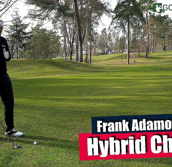 Golfer preparing to chip a ball on a lush green course with trees in the background.